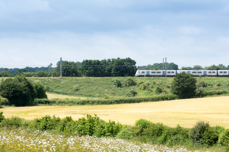 Train on the railway travelling through rural countrysideの写真素材