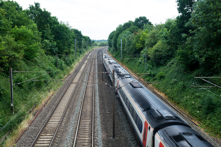 Fast train travelling on the tracks, passenger trainの写真素材