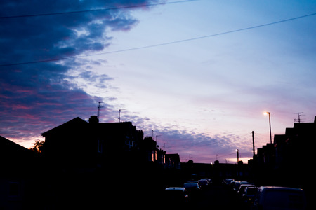 Night time view of house exterior of terraced houses on a streetの写真素材