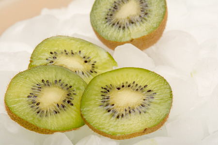 Sliced fresh Kiwi fruit arranged on iceの写真素材