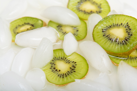 Sliced fresh Kiwi fruit arranged on iceの写真素材