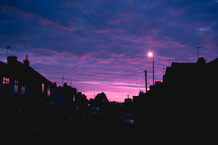 Night time view of house exterior of terraced houses on a streetの写真素材