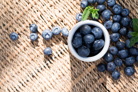 Blueberries. Freshly picked blueberry in ceramic bowl with berries and natural background. Blueberries are known to contain anitoxidant for nutrition health benefitsの写真素材