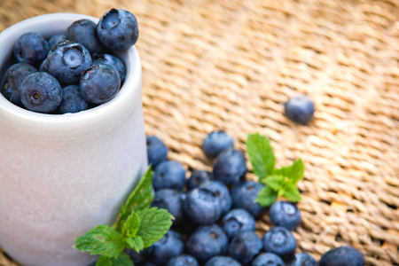 Blueberries. Freshly picked blueberry in ceramic bowl with berries and natural background. Blueberries are known to contain anitoxidant for nutrition health benefitsの写真素材