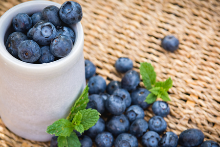 Blueberries. Freshly picked blueberry in ceramic bowl with berries and natural background. Blueberries are known to contain anitoxidant for nutrition health benefitsの写真素材