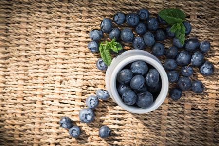 Blueberries. Freshly picked blueberry in ceramic bowl with berries and natural background. Blueberries are known to contain anitoxidant for nutrition health benefitsの写真素材