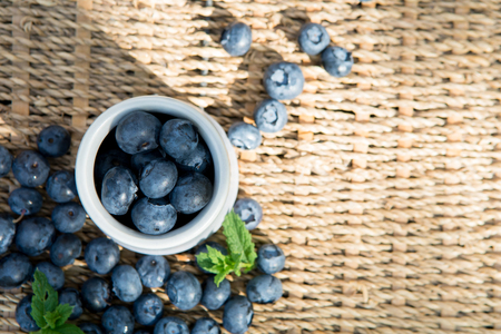 Blueberries. Freshly picked blueberry in ceramic bowl with berries and natural background. Blueberries are known to contain anitoxidant for nutrition health benefitsの写真素材