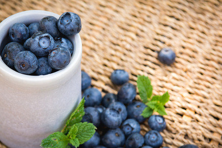 Blueberries. Freshly picked blueberry in ceramic bowl with berries and natural background. Blueberries are known to contain anitoxidant for nutrition health benefitsの写真素材