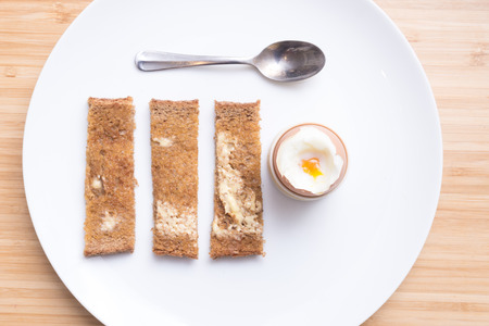 Soft boiled eggs with toast on a white plate. Breakfastの写真素材