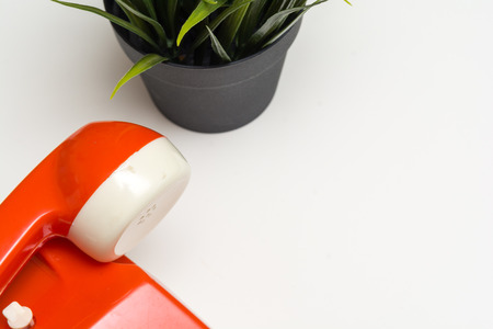 Retro style phone on a white office tableの写真素材
