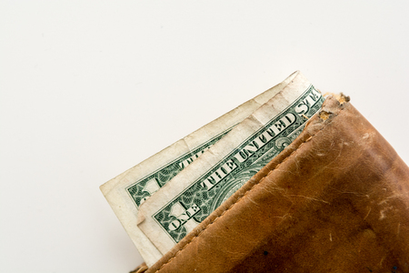 Old leather wallet with notes and moneyの写真素材