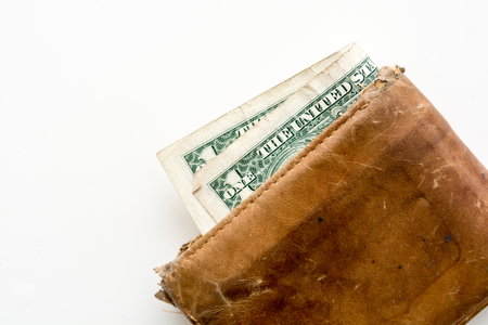 Old leather wallet with notes and moneyの写真素材