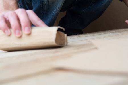 Man working with sand paper in carpentry tradeの写真素材