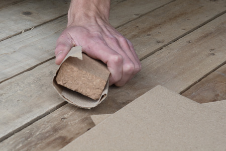 Man working with sand paper in carpentry tradeの写真素材
