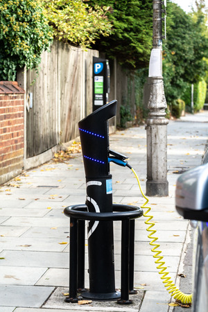 Hybrid car charging at a public charging pointの写真素材