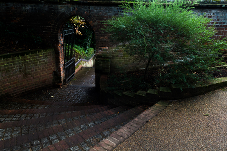 Steps down to an arched door way outsideの写真素材