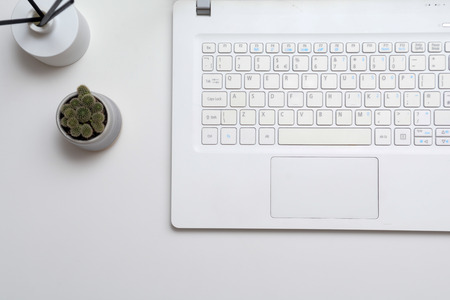 Laptop computer on modern office desk with blank screenの写真素材