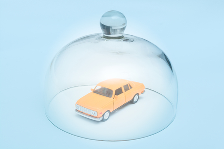 Car and automobile insurance, model car is protected by glass domeの写真素材