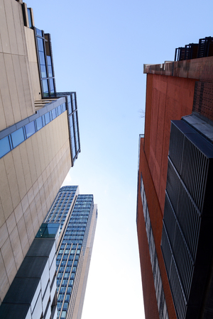 View of tall city office buildings from belowの写真素材