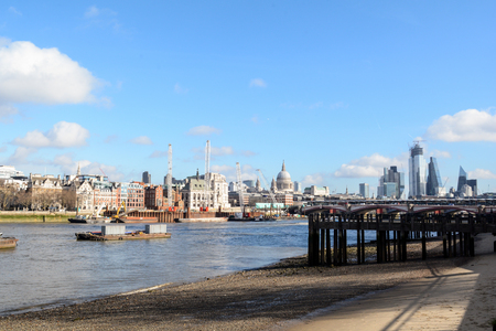 River Thames in London at low tide with exposed sand. View of the city in the backgroundの写真素材