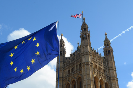 E.U. Flag flying in front of Union ack flag at Houses of Parliament Londonのeditorial素材