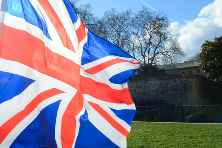 Union Jack flag flying over grass at parliament square Londonの写真素材