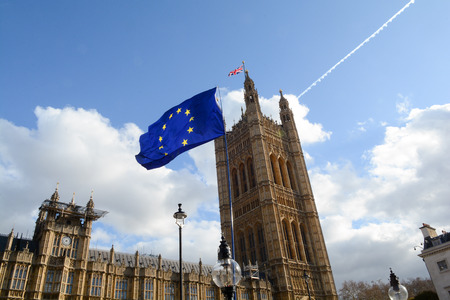 E.U. Flag flying in front of Union ack flag at Houses of Parliament Londonのeditorial素材