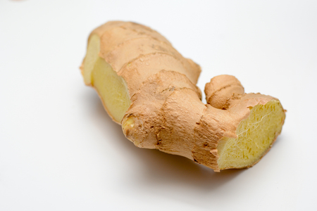 Fresh Ginger root cut and isolated on whiteの写真素材