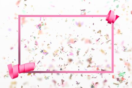 Congratulations greeting card with bright colour confetti explosion in background, pink ribbon and copy space for special messageの写真素材
