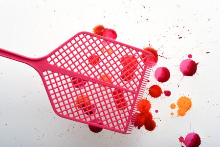 Fly swatter with splashes of fake blood from swatted flies and insects