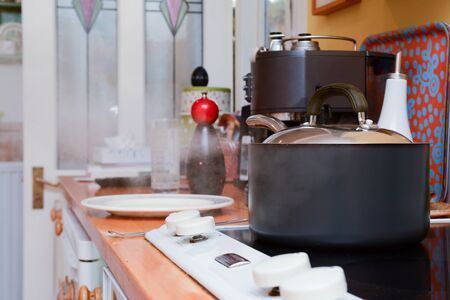 Cooking dinner at home in the kitchen, steam coming from under a saucepan lidの写真素材
