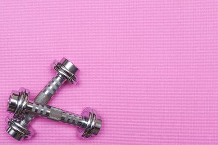 Yoga mat and excercise equipment for gym training and lifting weights with dumbbellsの写真素材