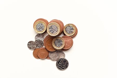 Coins isolated on white British currency representing uk economy and marketsの写真素材