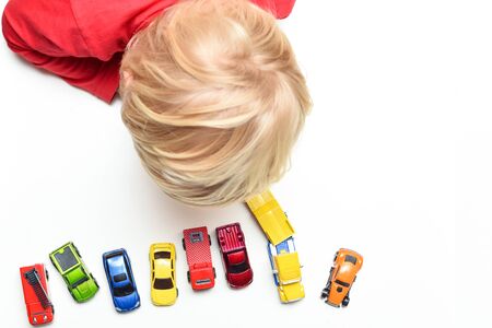Boy plays with toy cars at home high angle view from directly above childの写真素材