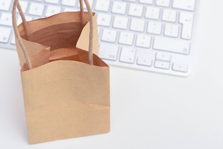 Online shopping and e-commerce Blank paper bag with computer keyboard for home deliveryの写真素材