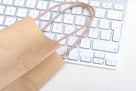 Online shopping and e-commerce Blank paper bag with computer keyboard for home deliveryの写真素材