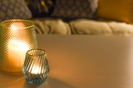 Cosy room interior inside a family home living room with candle light