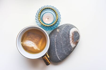 Calming camomile tea in a mug with arrangement of modern objects view from aboveの写真素材