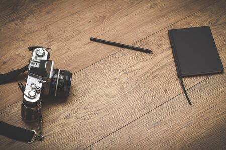 Retro style objects for blogging photography and writing on vintage wooden backgroundの写真素材