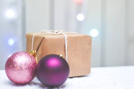 Gift wrapped christmas present with decorations and glowing fairy lightsの写真素材