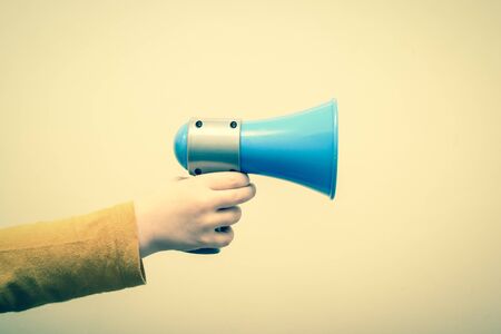 Retro style megaphone announcement background with vintage border and hold holding speakerの写真素材