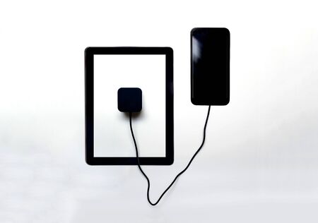 Sharing battery and power between devices, charging from device to device concept to extend battery life on smart phoneの写真素材