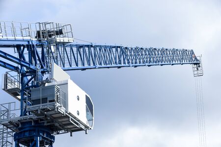 Large blue crane on a construction site on a commercial development with sky in the background