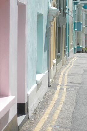 Row of painted houses in pastel shades on a sunny street