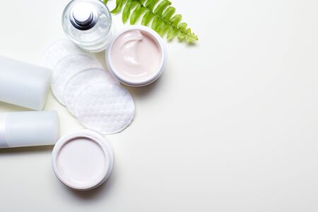 Facial cleansing products and containers with face creams and cotton wool padsの写真素材