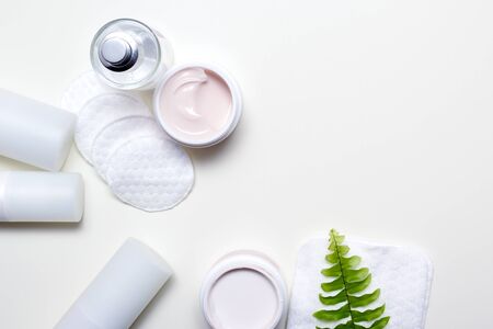 Facial cleansing products and containers with face creams and cotton wool padsの写真素材