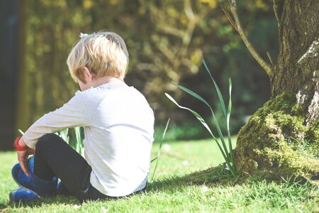 Siblings playing together a boy and girl are playing outside in a garden during daytime