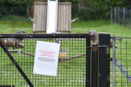 Sign on closed park and play area due to possible infection from covid 19 virusの写真素材