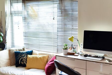 Home working area with office desk set up in living roomの写真素材