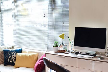 Home working area with office desk set up in living roomの写真素材